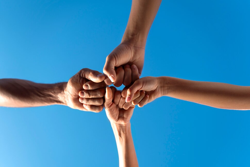 Hands coming together in a circle representing unity and collaboration